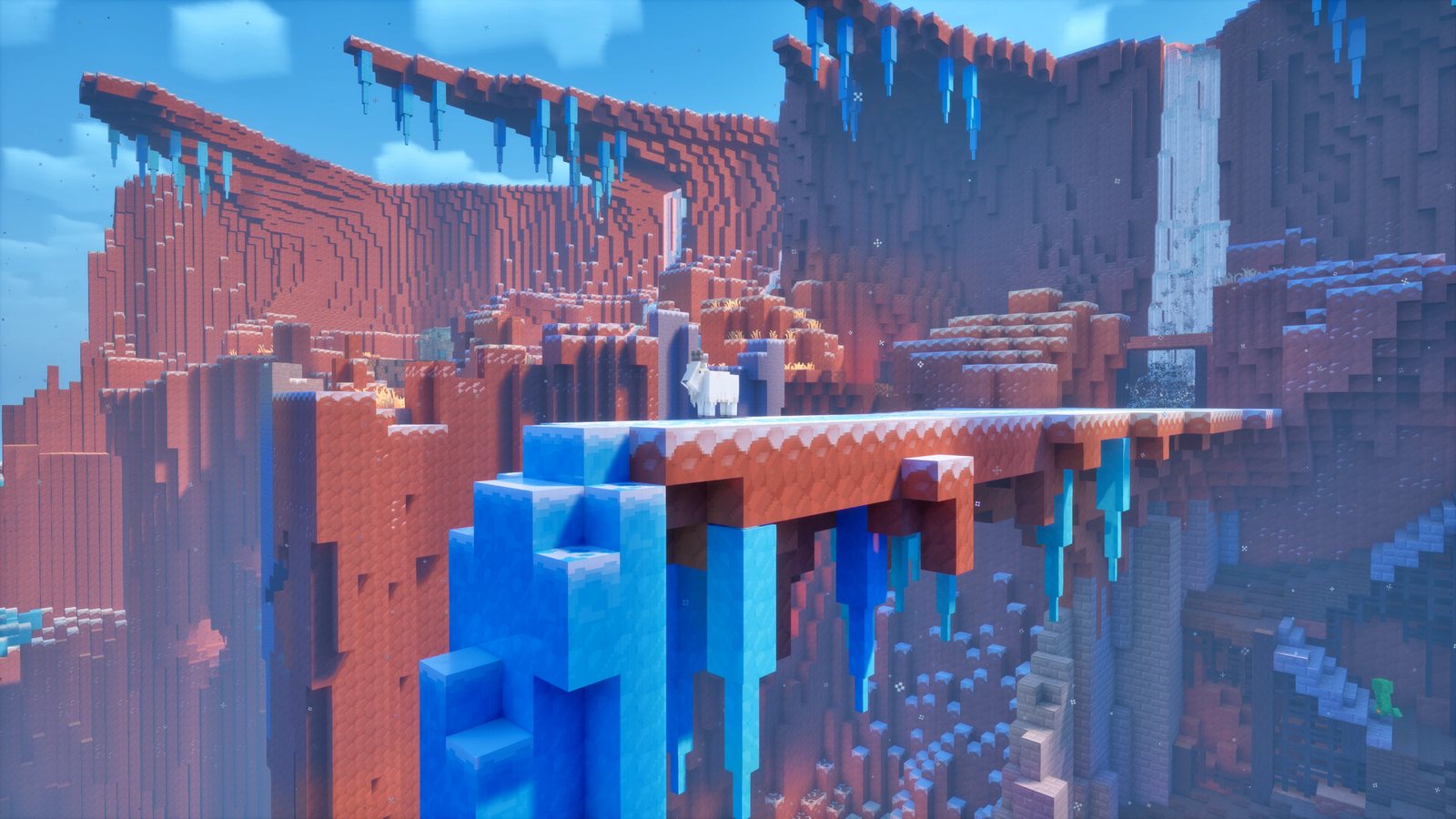 An icy canyon region in Minecraft Dungeons II with red rock walls, hanging blue icicles and a goat standing on a bridge